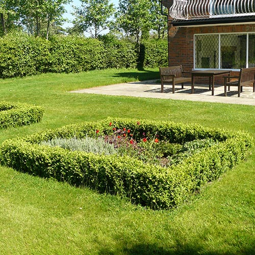 French style Garden Brick paver edged sandstone terrace