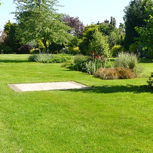 French style Garden Brick paver edged sandstone seating area